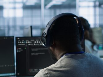 Admin working in computer network security data center listening music